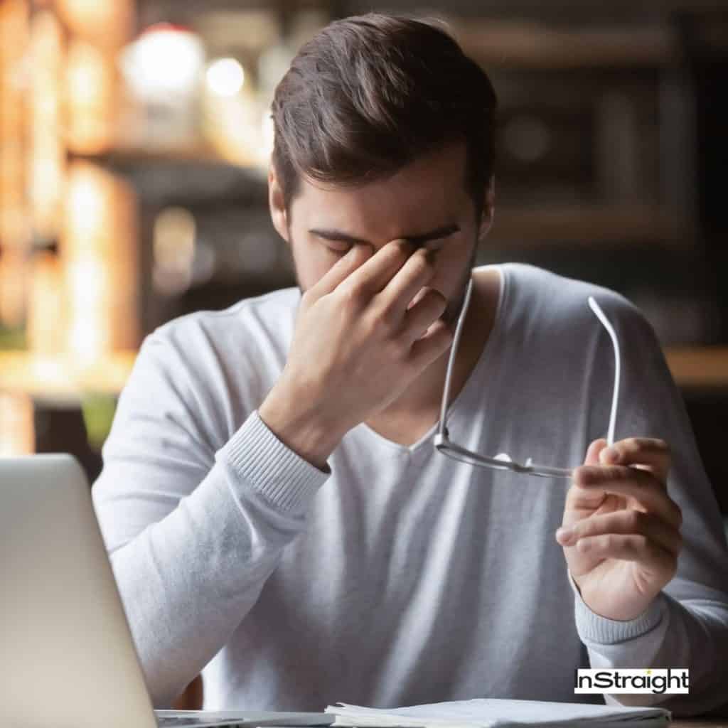 A man removes glasses to scratch eyes under title Are LED Makeup Mirrors Bad For Your Eyes?